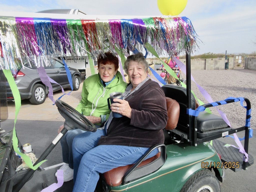 Bev Wilson and friend on a golf cart
