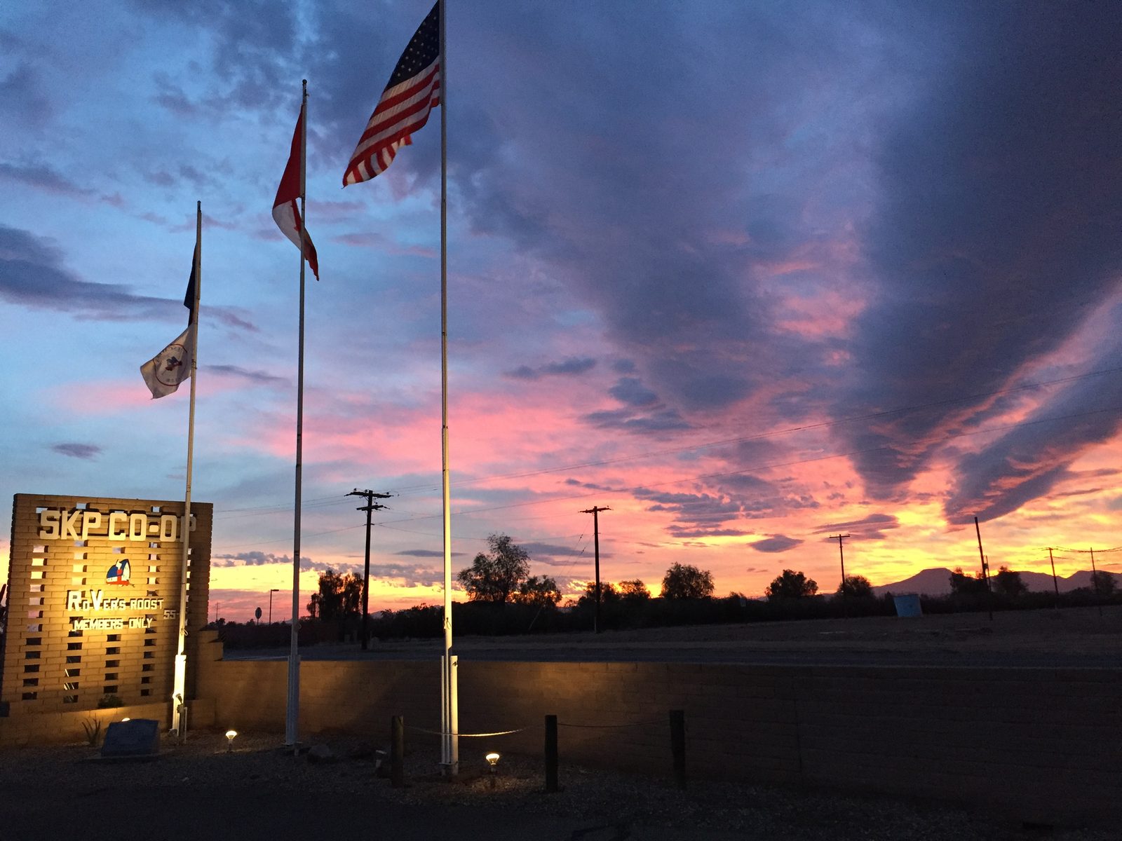 Sign and flags at sunset
