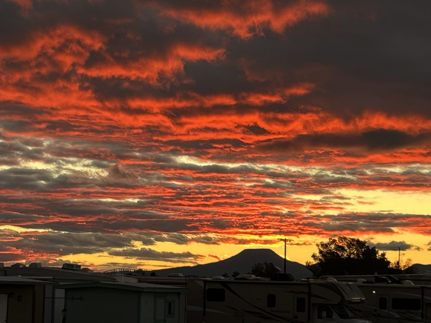Dramatic desert sunset over the mountains at RoVer's Roost RV Retreat.